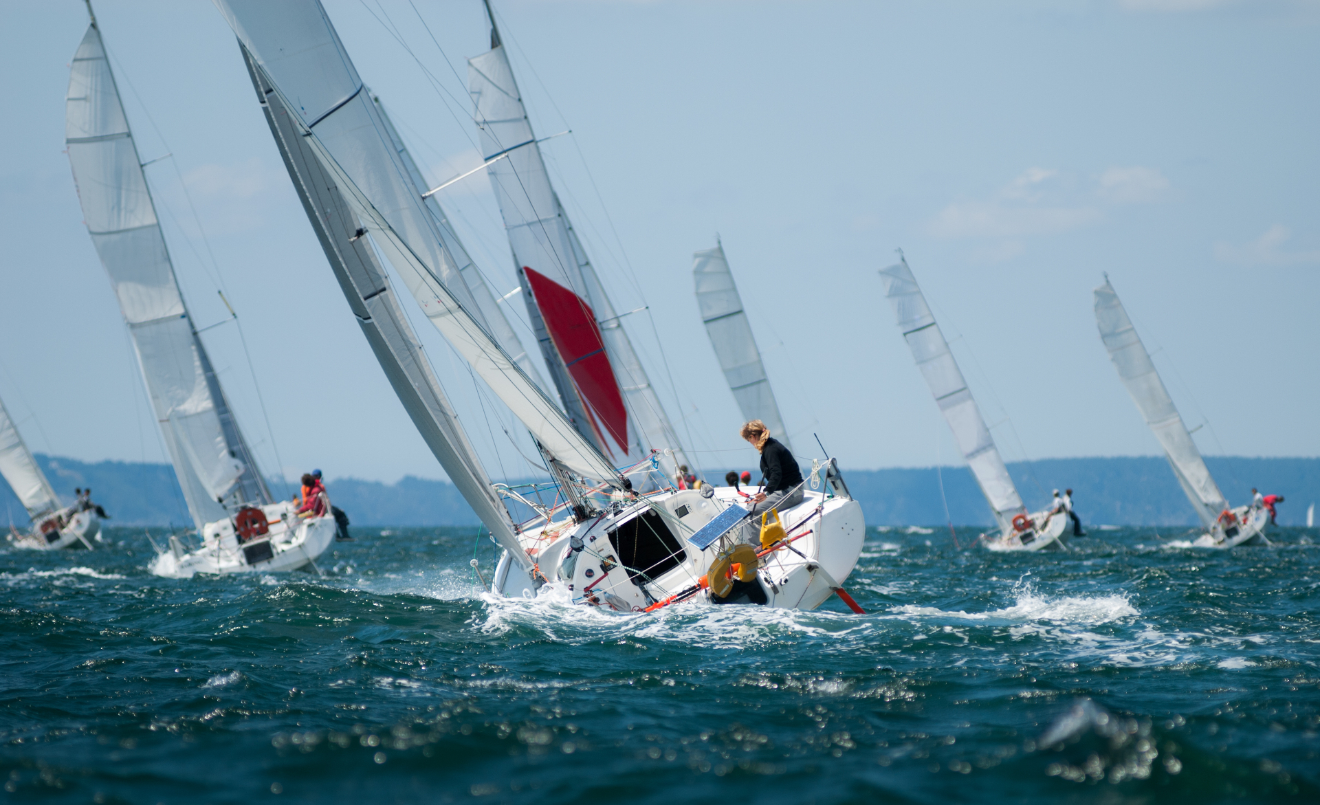 Team of sailboats racing together representing team alignment